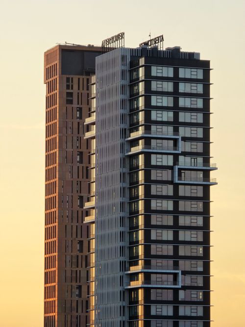 Free Two modern skyscrapers against a sunset sky, showcasing architectural design. Stock Photo
