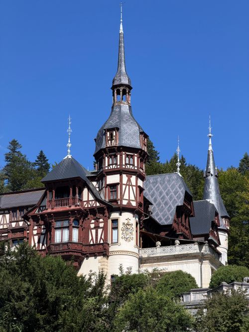 Free Iconic Peleș Castle in Sinaia, Romania, captured on a sunny day, highlighting its architectural beauty. Stock Photo