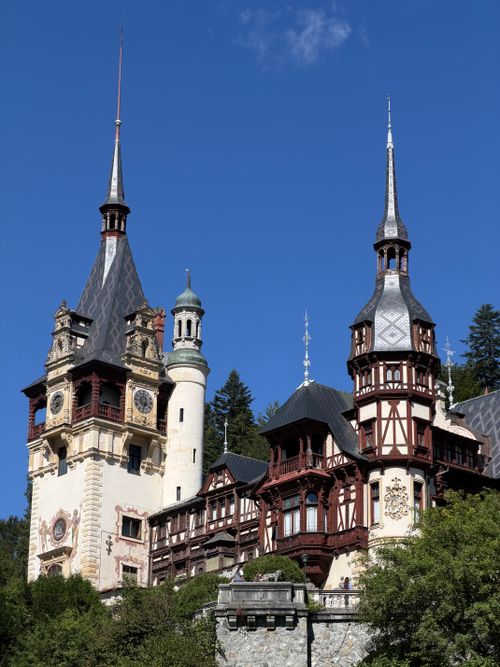 Free Stunning view of Peleș Castle's intricate towers in Sinaia, Romania against a bright blue sky. Stock Photo
