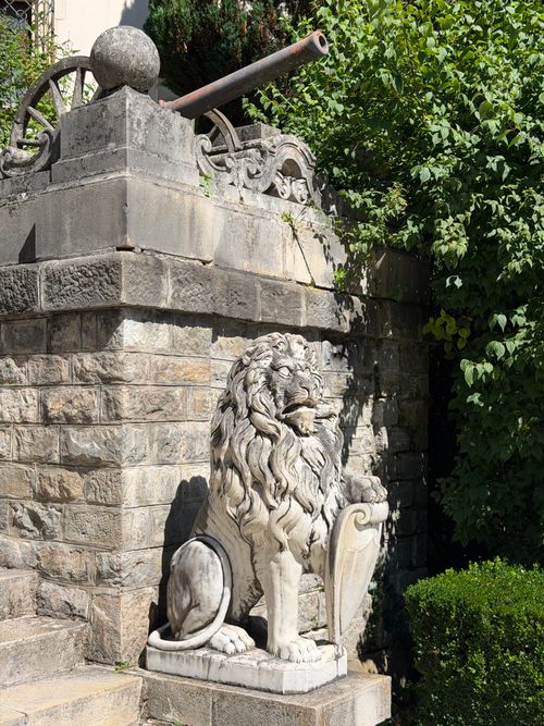 Free Stone lion statue in bright surroundings at a historic site in Sinaia, Romania. Stock Photo