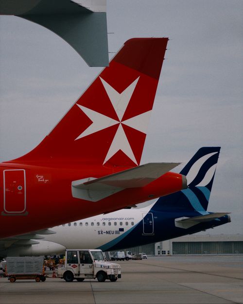 Free Close-up of airplane tails lined up at Munich Airport, showcasing different airlines. Stock Photo