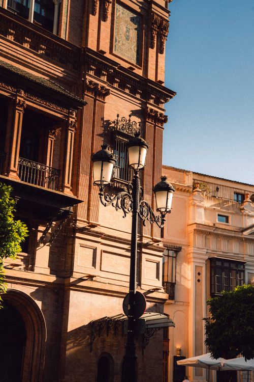 Free Charming street scene showcasing historic architecture in Seville, Spain during a sunny day. Stock Photo
