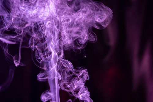 Free Ethereal purple smoke swirls creating a dynamic and artistic abstract design against a dark background. Stock Photo