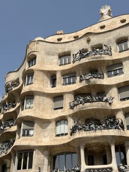 Detailed view of Casa Milà's iconic wavy stone facade in Barcelona, Spain.