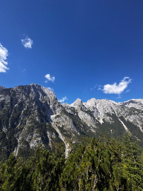 Free Breathtaking view of Slovenia's Julian Alps on a sunny day. Ideal for nature and travel enthusiasts. Stock Photo