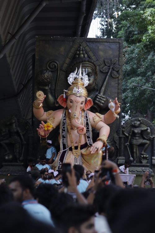 Free Crowd gathers around a large Lord Ganesha idol at an outdoor festival. Stock Photo