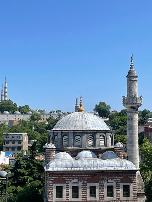 Free Traditional mosque architecture in Istanbul, showcasing intricate domes and minarets against a bright blue sky. Stock Photo
