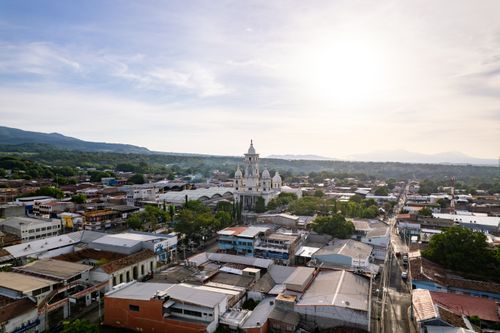 Free A stunning aerial view of Zacatecoluca, El Salvador, featuring a prominent church and surrounding landscape in morning light. Stock Photo