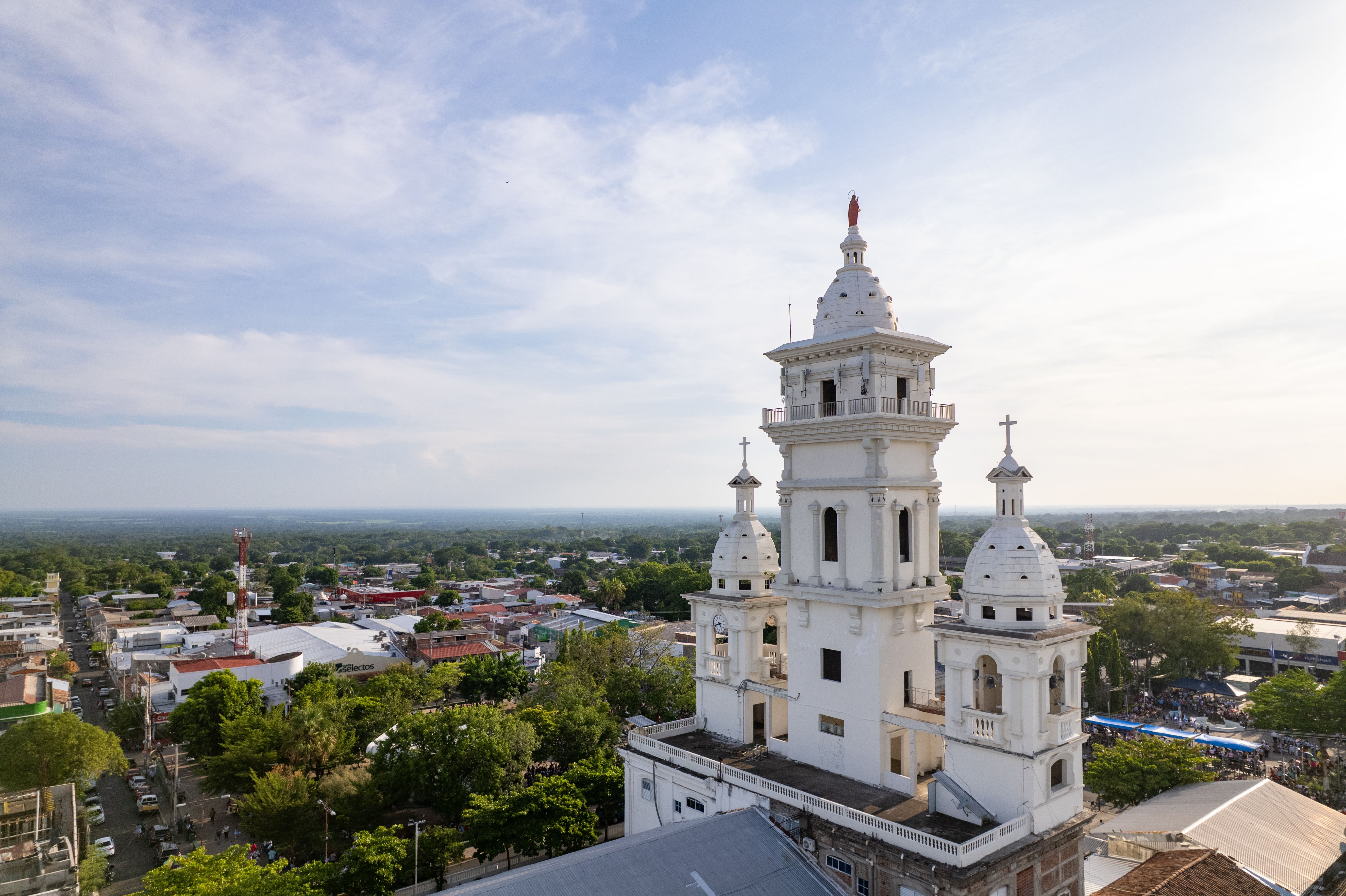 Stunning aerial view of a historic church surrounded by a vibrant cityscape in Zacatecoluca, El Salvador.