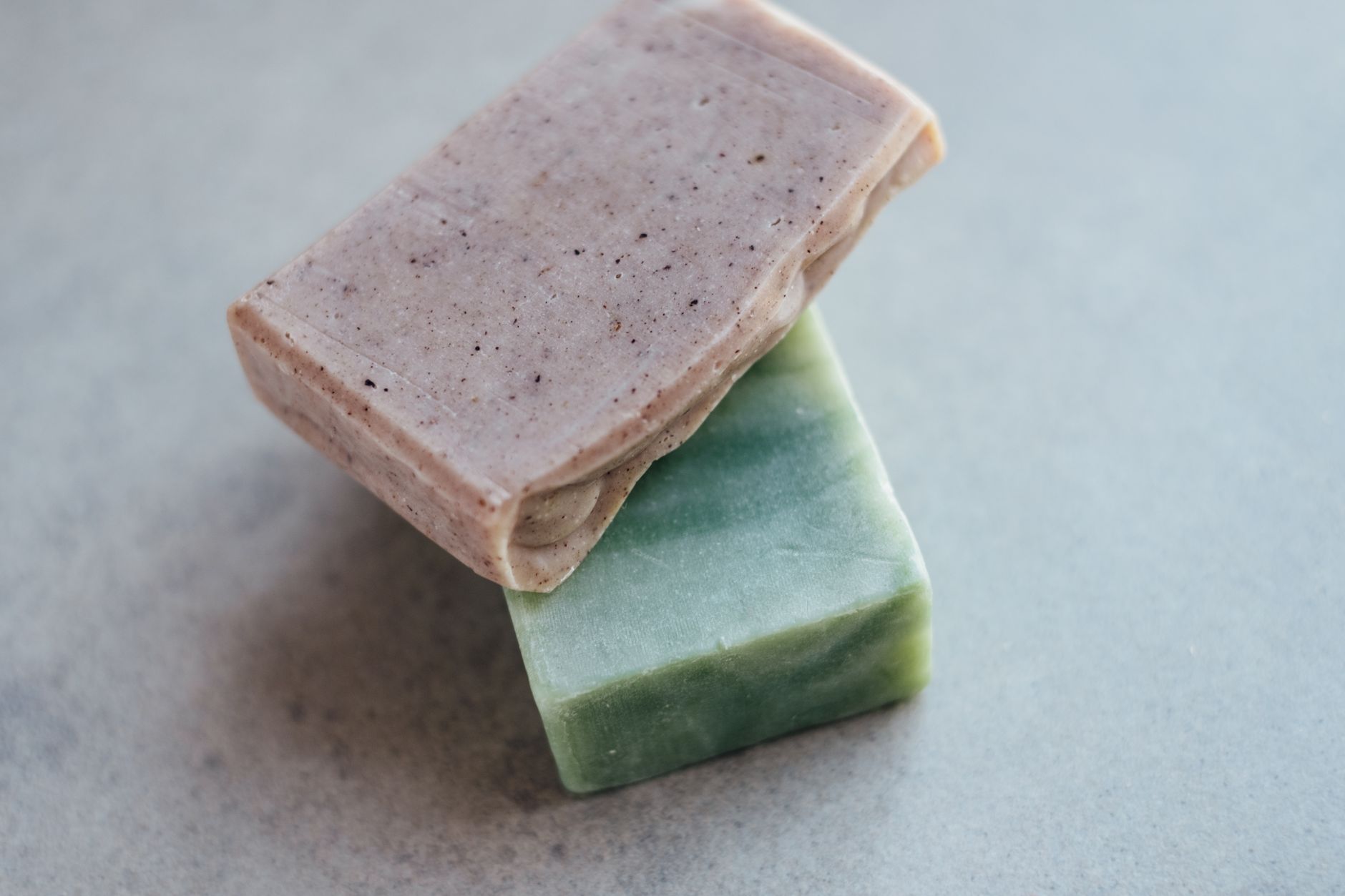 Close-up of two organic handmade soap bars, showcasing natural textures and colors.