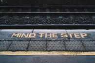 Platform with inscription near railway on city street