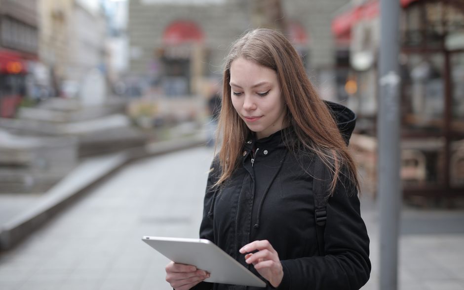 Person connecting to public Wi-Fi on a laptop in a British cafe