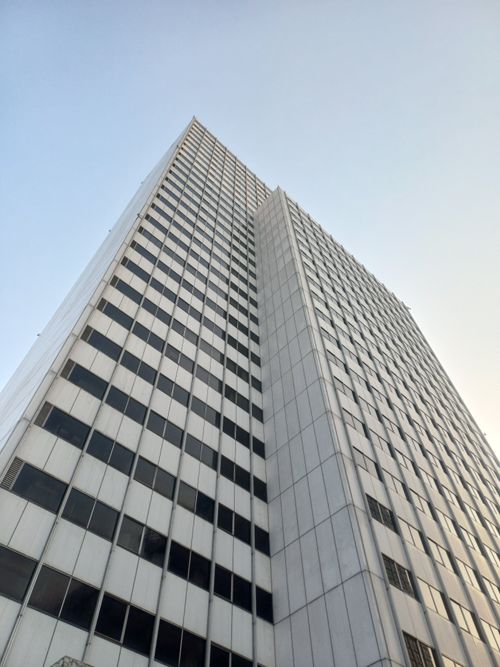 Free View of a modern skyscraper's facade in Jakarta under a clear sky, emphasizing urban architecture. Stock Photo