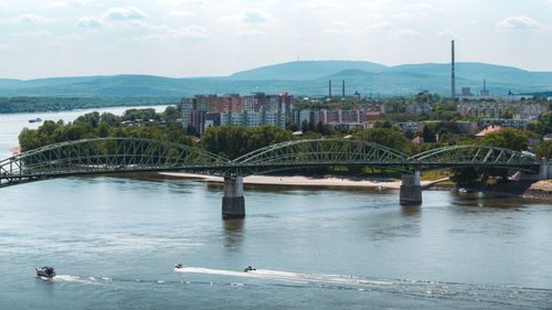 Free Bridge spanning Danube River in Esztergom, Hungary with cityscape and boats. Stock Photo