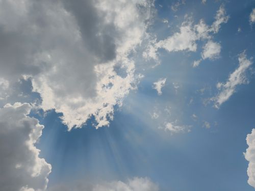 Free Captivating view of sun rays piercing through clouds in Silchar, India, creating a dramatic sky. Stock Photo