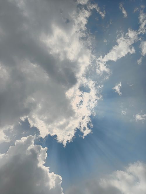 Free Dramatic sky with sun rays breaking through clouds. Captured in Silchar, India. Stock Photo