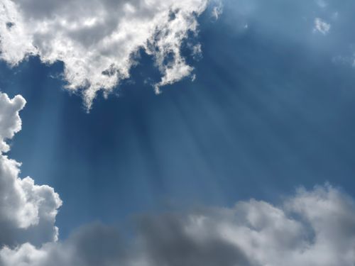 Free Beautiful sunlight beams through textured clouds, creating a dramatic sky scene over Silchar, India. Stock Photo