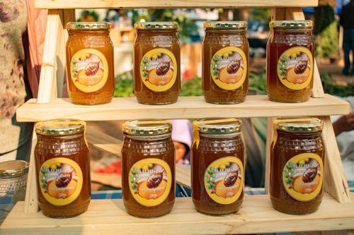 Free A vibrant display of organic honey jars at a local Manzini market in Eswatini, showcasing local produce. Stock Photo
