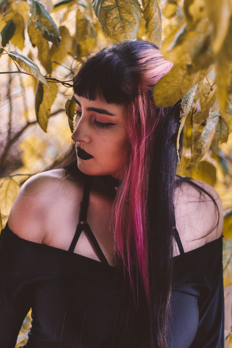 Woman With Pink Highlights Wearing A Black Spaghetti Strap Top