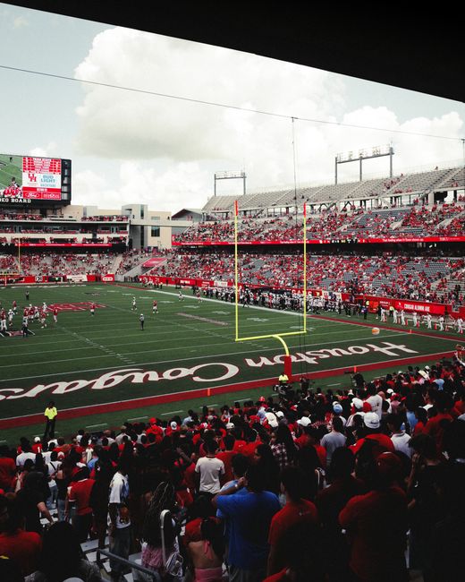 A family cheering at NRG Stadium while reviewing their NFL game day budget.