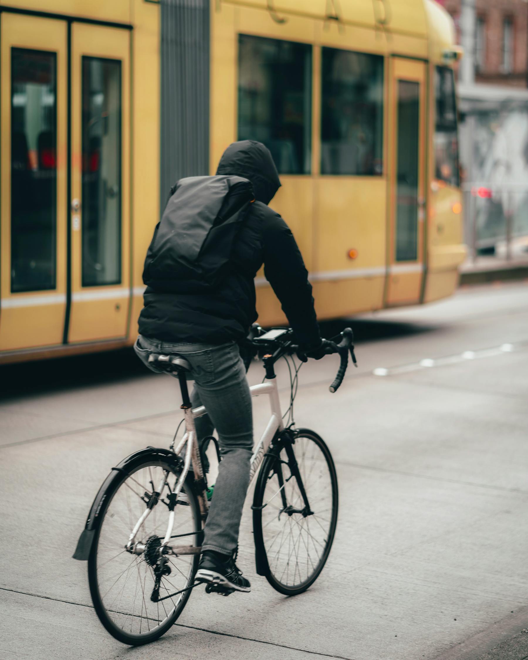 Man In Black Jacket Riding A Bicycle