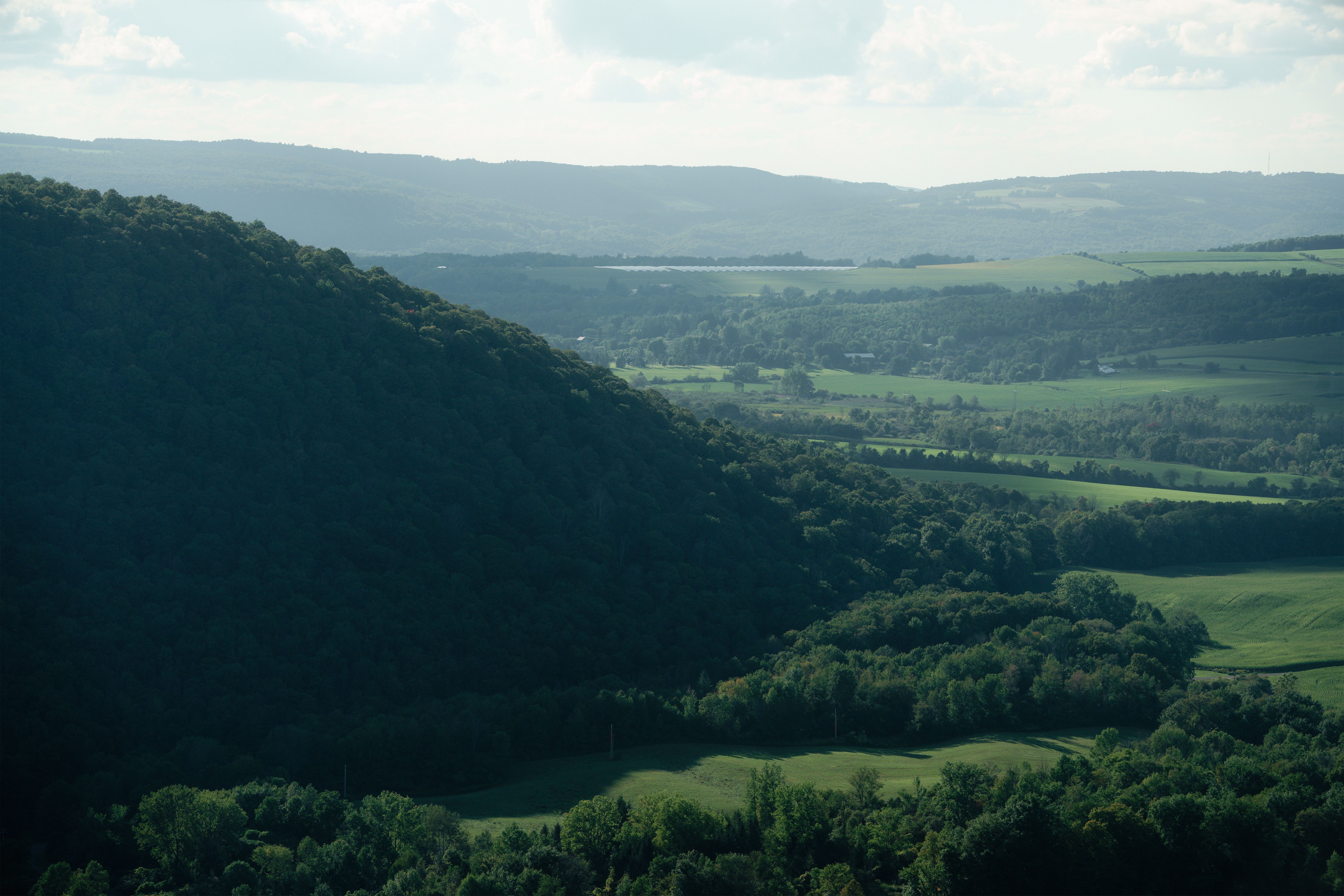 Breathtaking aerial view of Tully Valley's lush green landscape in summer.
