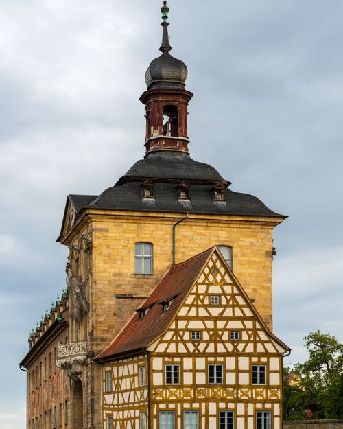 Free Charming blend of half-timbered and Baroque architecture in a serene outdoor setting. Stock Photo