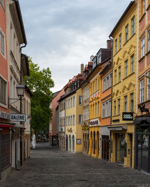 Free Picturesque view of a quaint European street with colorful historic buildings and a cozy atmosphere. Stock Photo