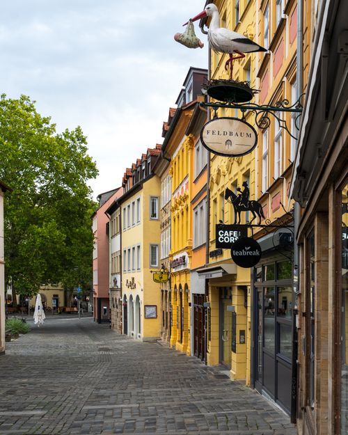 Free Quaint street scene with colorful buildings and cafes in a picturesque European town. Stock Photo