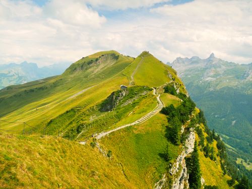Free Breathtaking view of an alpine hiking trail in the Swiss mountains during summer. Stock Photo