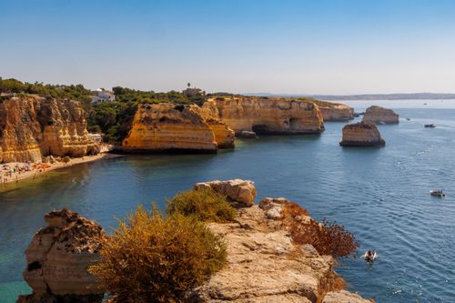 Free Breathtaking view of Algarve cliffs and clear blue waters, perfect for summer travel. Stock Photo