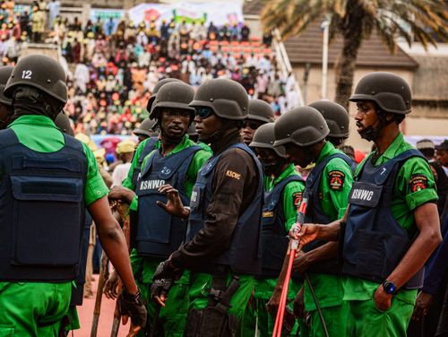 Free A group of uniformed security personnel gathered at a crowded outdoor event. Stock Photo