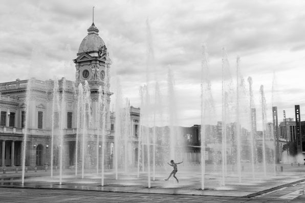 Free Monochromatic image of a child frolicking in a water fountain at Station Square, Belo Horizonte, Brazil. Stock Photo