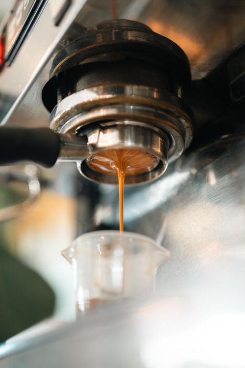 Free Close-up of rich espresso pouring from a coffee machine into a cup. Stock Photo