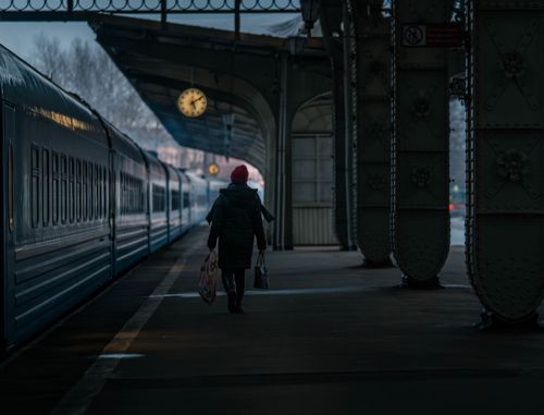 Free A solitary traveler walks along a platform at a historic train station in St. Petersburg, Russia. Stock Photo