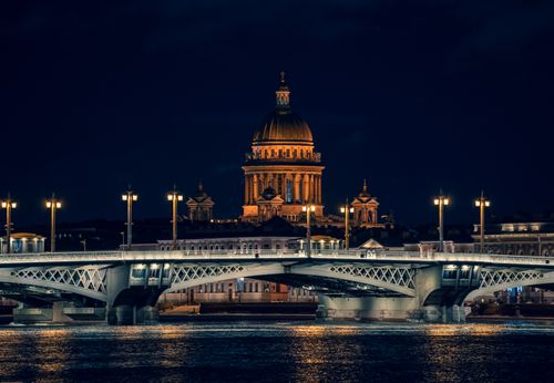 Free Illuminated view of St. Isaac's Cathedral and bridge over river at night. Stock Photo