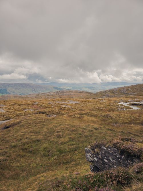 Free Explore the dramatic and serene beauty of Ireland's rolling hills under a moody sky. Ideal for travel enthusiasts. Stock Photo