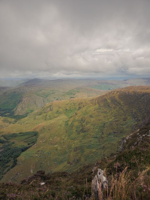 Free Scenic view of lush green mountains under a cloudy sky in Ireland. Stock Photo