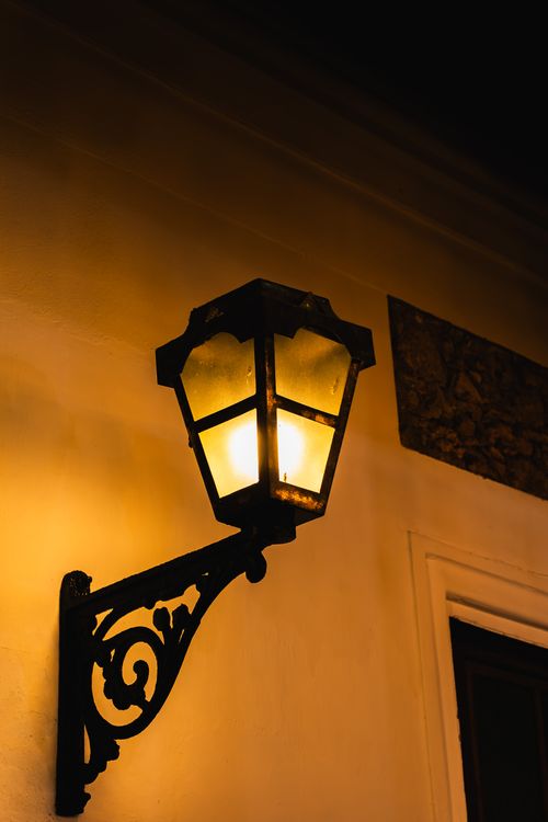 Free A classic street lamp casting a warm glow on a historic wall in Galle, Sri Lanka. Stock Photo