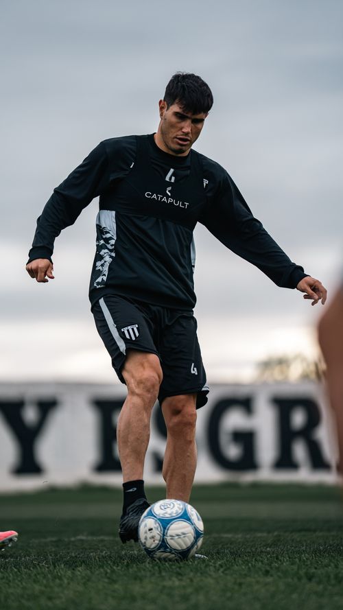 Free Focused soccer player practicing ball control outdoors on a cloudy day. Stock Photo