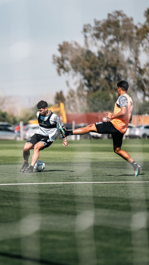 Free Two soccer players in action during a competitive game on an outdoor field. Stock Photo
