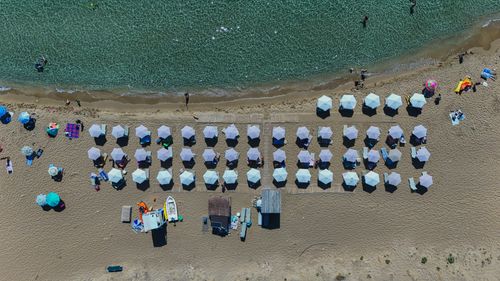 Free Aerial shot of beach umbrellas and clear water at a sunny Corfu beach, Greece. Stock Photo