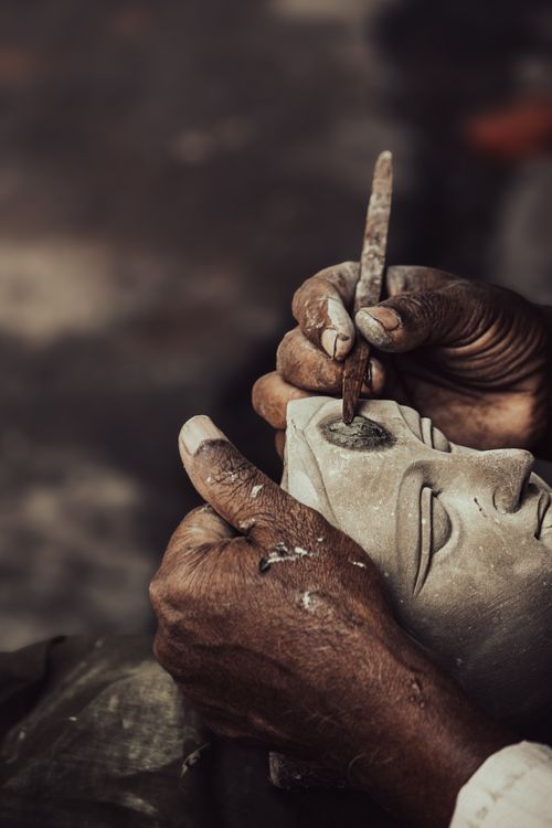 Free Close-up of an artisan handcrafting a clay mask in Kolkata, India, showcasing traditional craftsmanship. Stock Photo