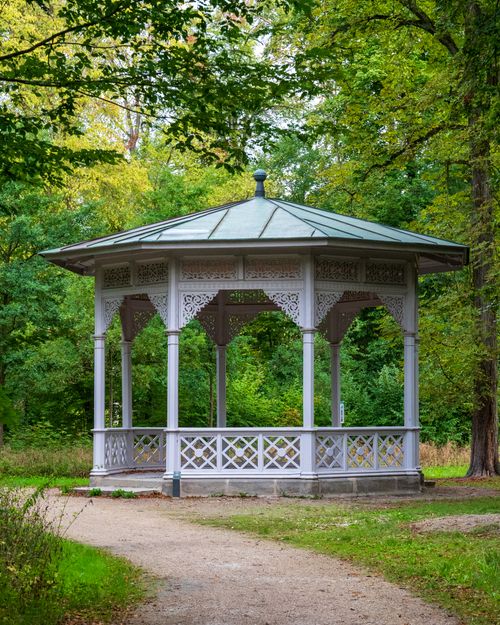 Free Beautiful gazebo surrounded by lush greenery in an urban park, showcasing nature and architecture. Stock Photo
