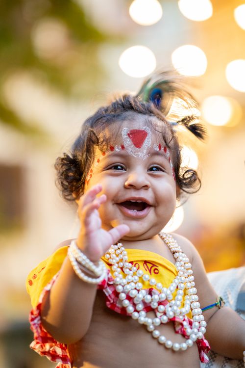 Free A smiling baby adorned with pearls and traditional markings, embodying cultural festivity. Stock Photo
