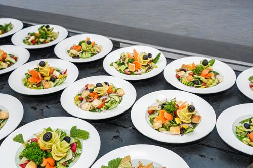 Free Multiple gourmet salad plates with vegetables and greens elegantly arranged on a table. Stock Photo