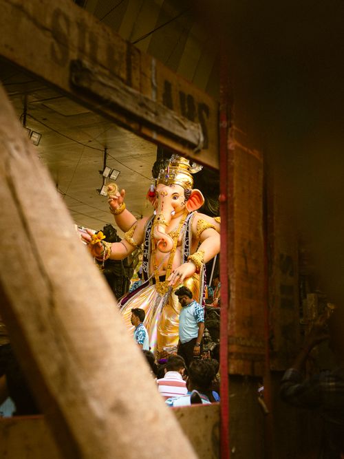 Free Vibrant scene of Ganesh Chaturthi festival with a towering Ganesha idol in Mumbai, India. Stock Photo