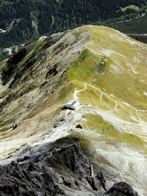 Free A breathtaking aerial shot of a mountain trail and hut set in Trentino-Alto Adige, Italy. Stock Photo