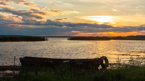 Free Tranquil sunset scene with a boat on the lake in Braslav, Belarus. Stock Photo