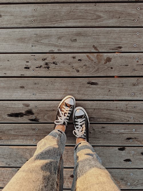 Free Person In Denim Jeans And Black And White Sneakers Stock Photo